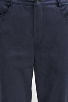 Close-up of dark navy trousers showing the front waistband, belt loops, button closure, and side pocket edges.