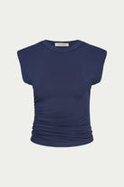 A navy blue sleeveless top with a crew neck and gathered ruching at the waist, shown against a light gray background.