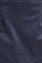 Close-up of a dark navy blue fabric surface with a subtle sheen and soft folds.
